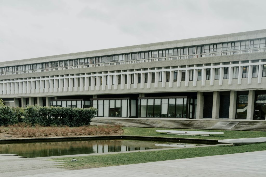 View of Simon Fraser University's Brutalist architecture with a reflecting pond in Burnaby, Canada.